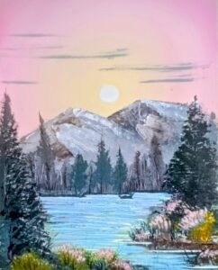 Mountains and river framed by trees